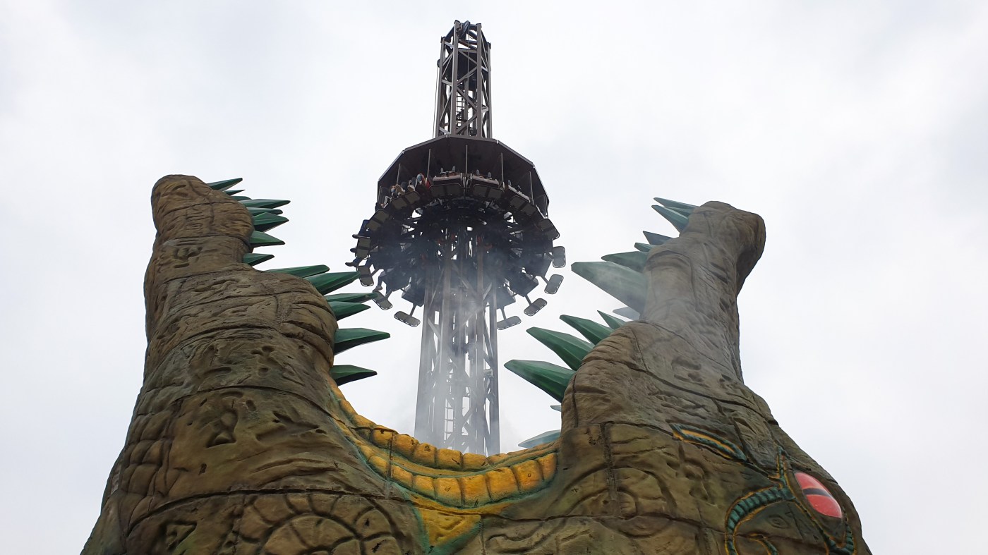 Upward view of Croc Drop at Chessington looking at riders dropping into the jaws of the giant theming feature