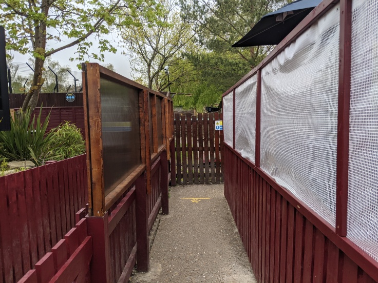 Plastic sheeting barriers in the queue of Dragon's Fury at Chessington