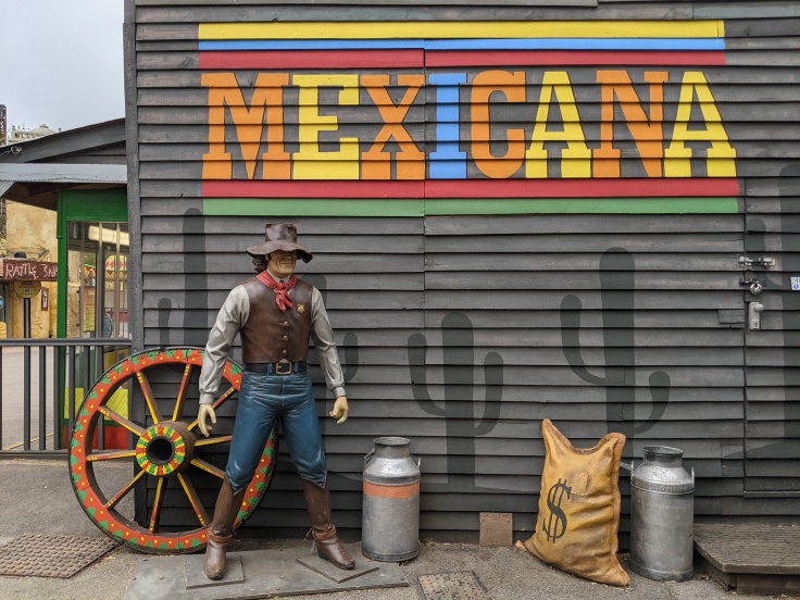 Mural featuring cowboy statue and painted cacti in Mexicana at Chessington