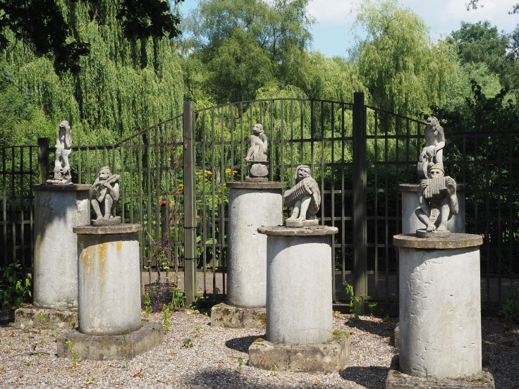 Six statues of monkeys with various musical instruments